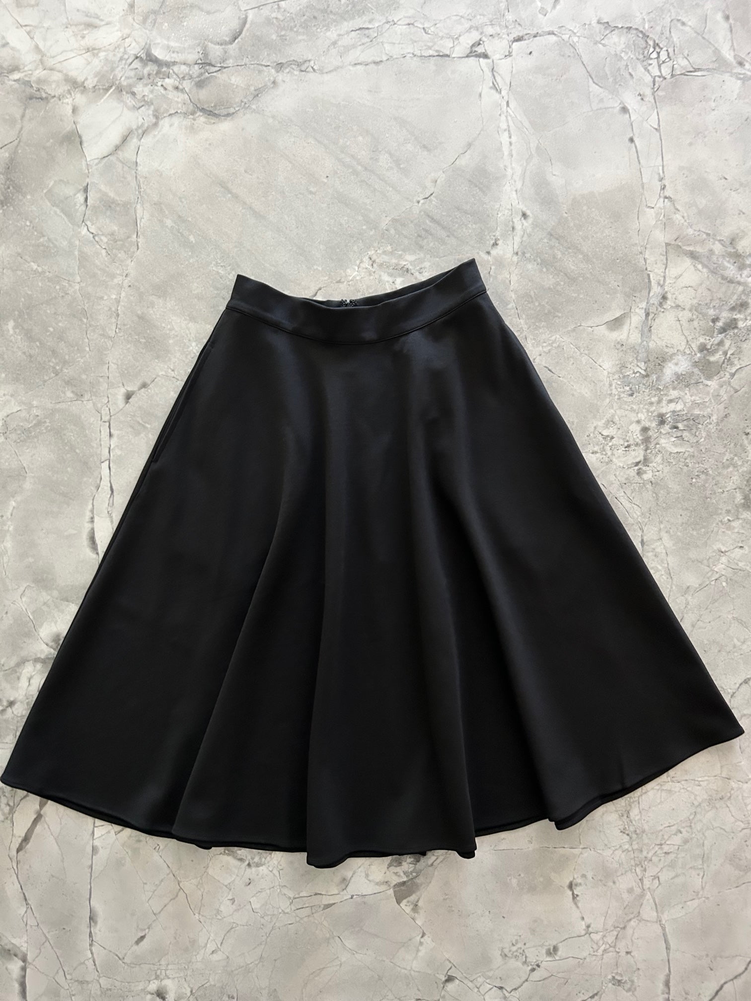 a flat lay image of the front of the Charlotte Nova skirt in black