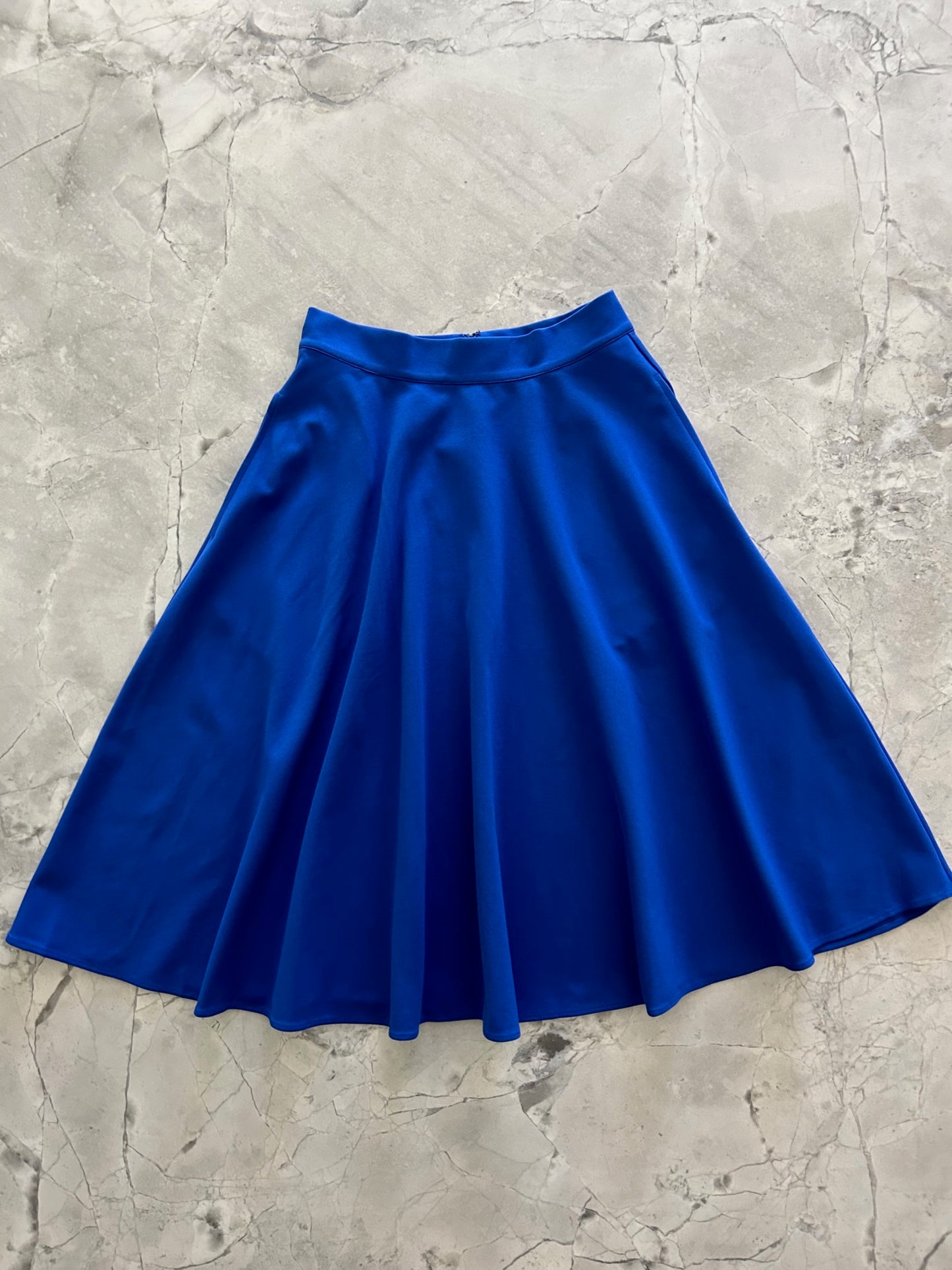 a flat lay image of the front of the Charlotte Nova skirt in blue