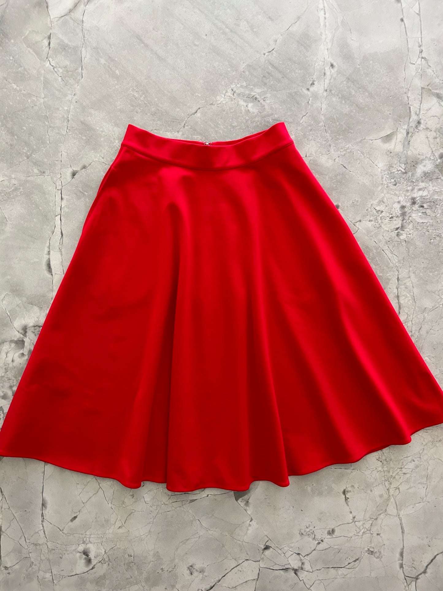 a flat lay image of the front of the Charlotte Nova skirt in red