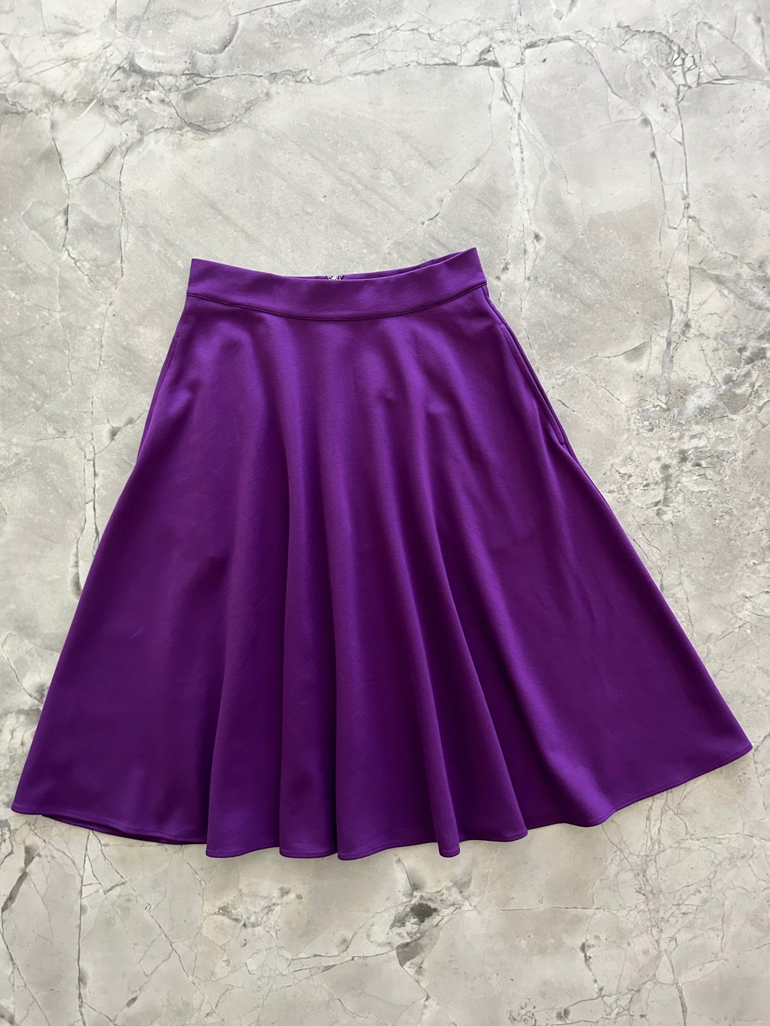 a flat lay image of the front of the Charlotte Nova skirt in purple