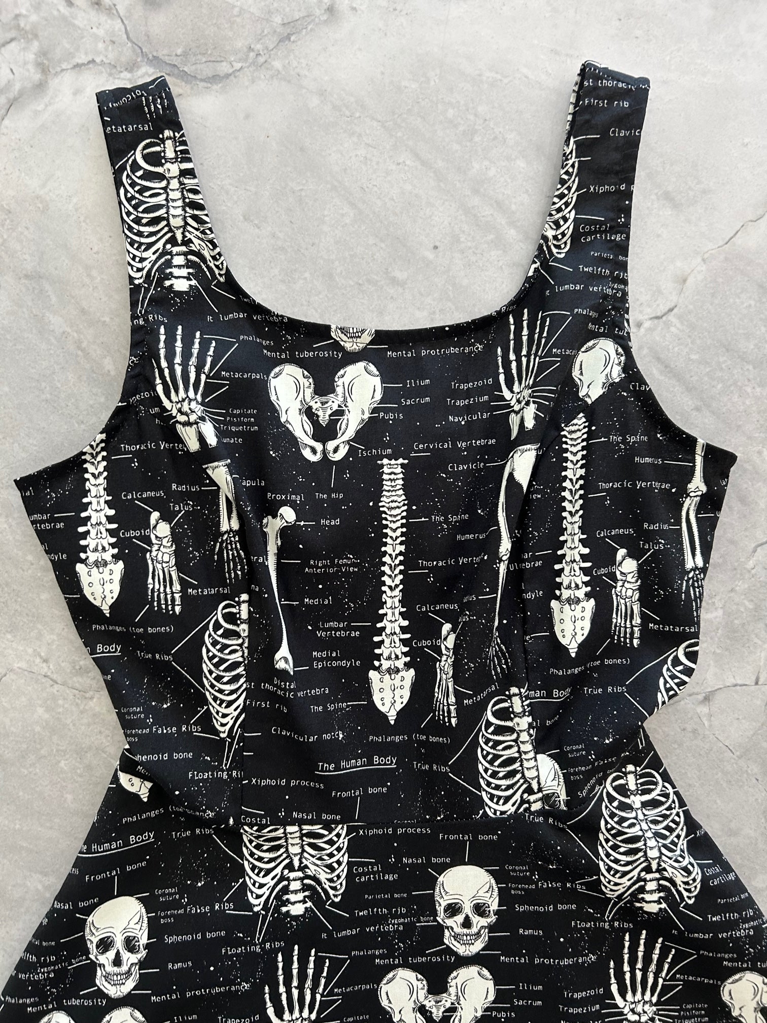a close up image of the bodice of our Glow Skulls & Bones Skater Dress