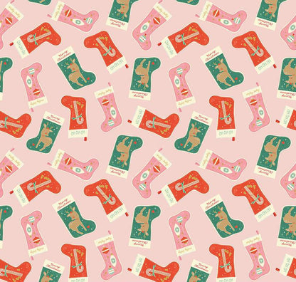 close up of fabric print showing red, green and pink stockings on a pink background