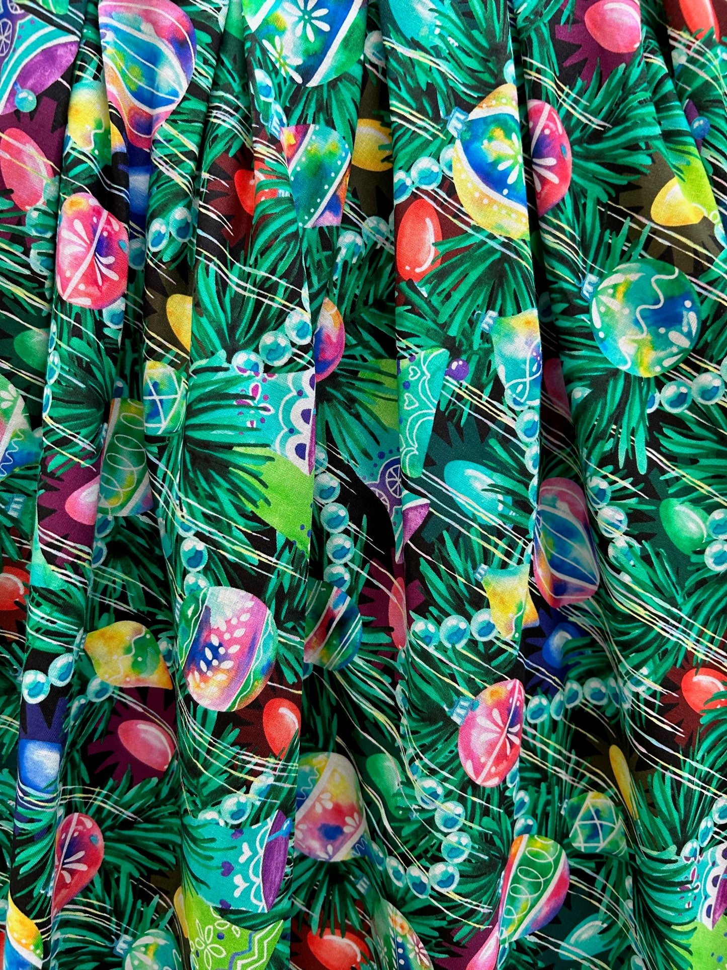 close up showing the colorful ornaments on a geen background