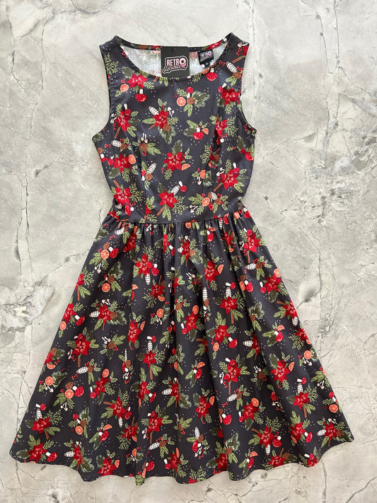 flat lay of the festive vintage dress showing full swing skirt and festive mushroom and flower design