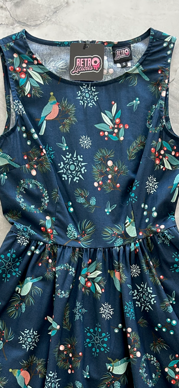 close up of the bodice showing th birds with winter hats, branches and snowflakes print
