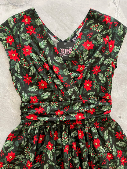 close up of the bodice of the holiday greta dress showing the surplus neckline and shirring at waist