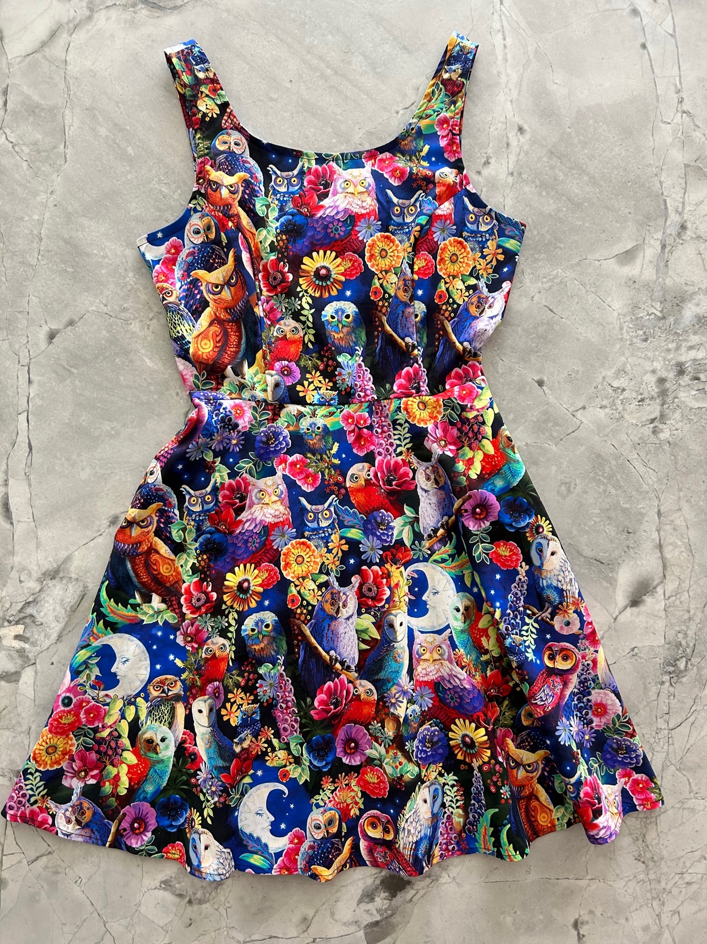a flat lay image of our owls skater dress showing the front of the dress layed out flat