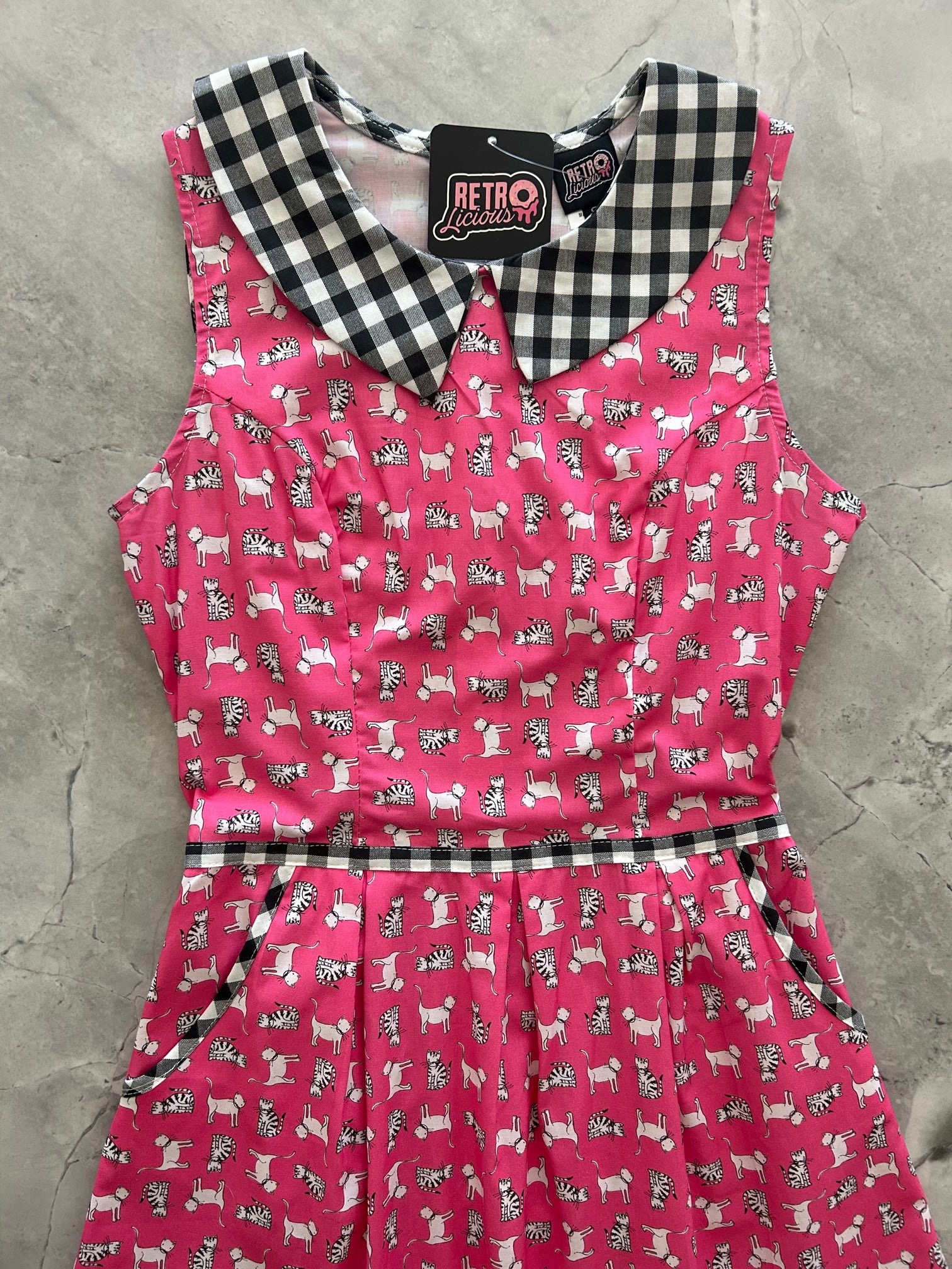 a close up flat lay showing the black and white gingham collar and contrast