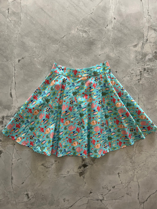 a flat lay of colorful fish skater skirt