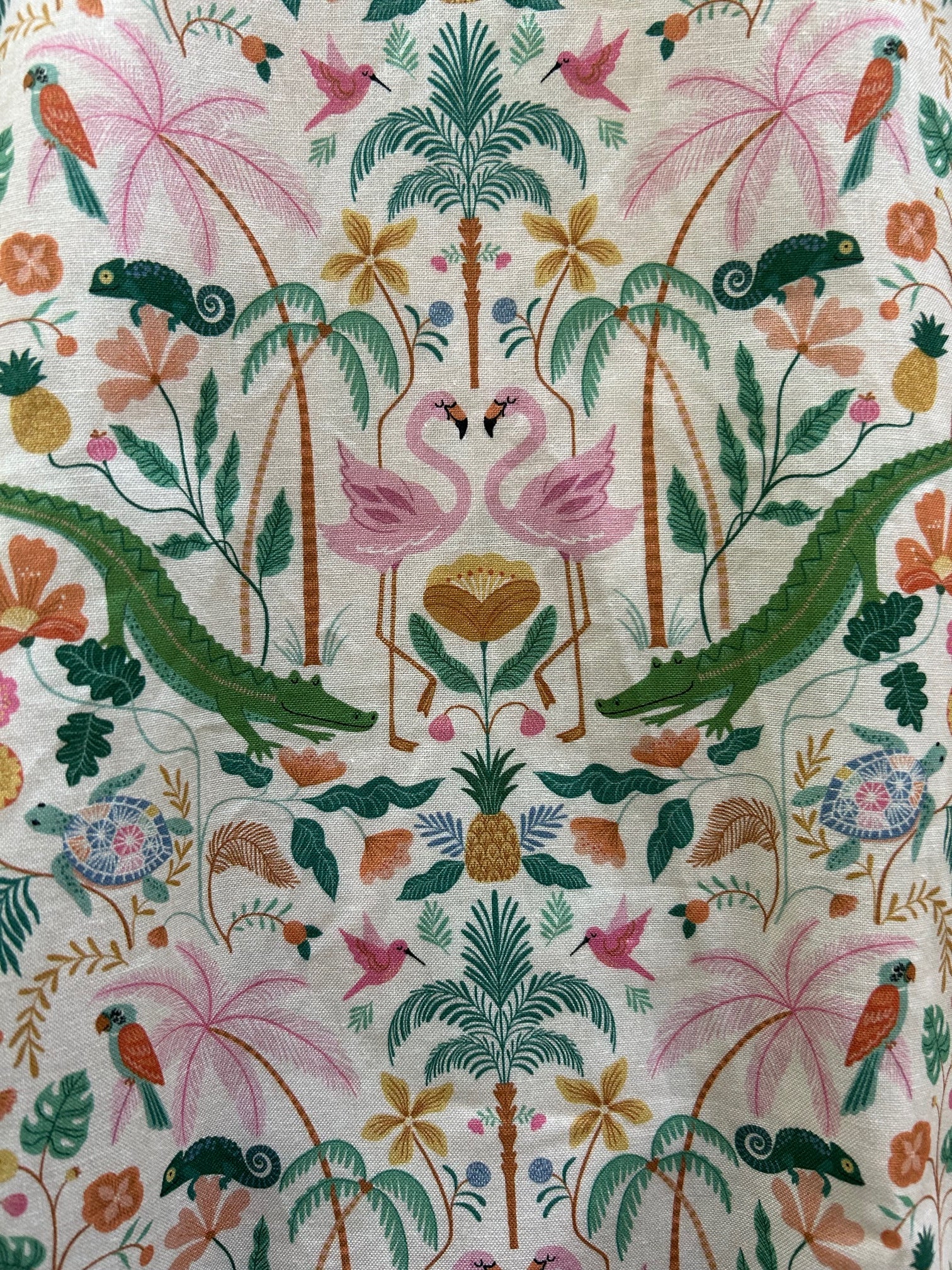close up of the fabric showing the details of the print with aligators, flamingoes and palm trees