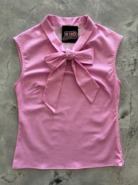 flat lay of pink dot bow top