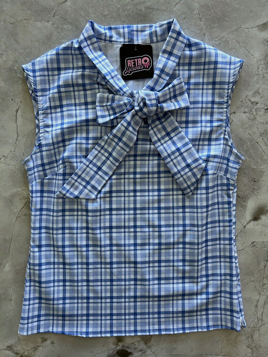 flat lay of blue plaid bow top