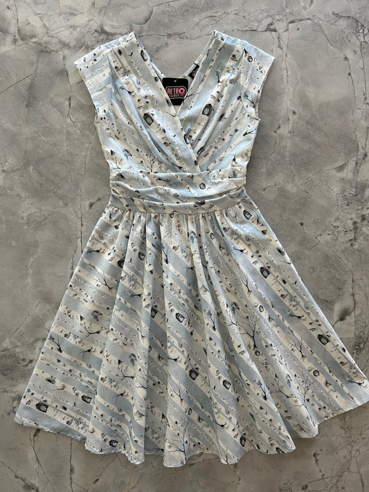 a flat lay of greta dress in birch trees print