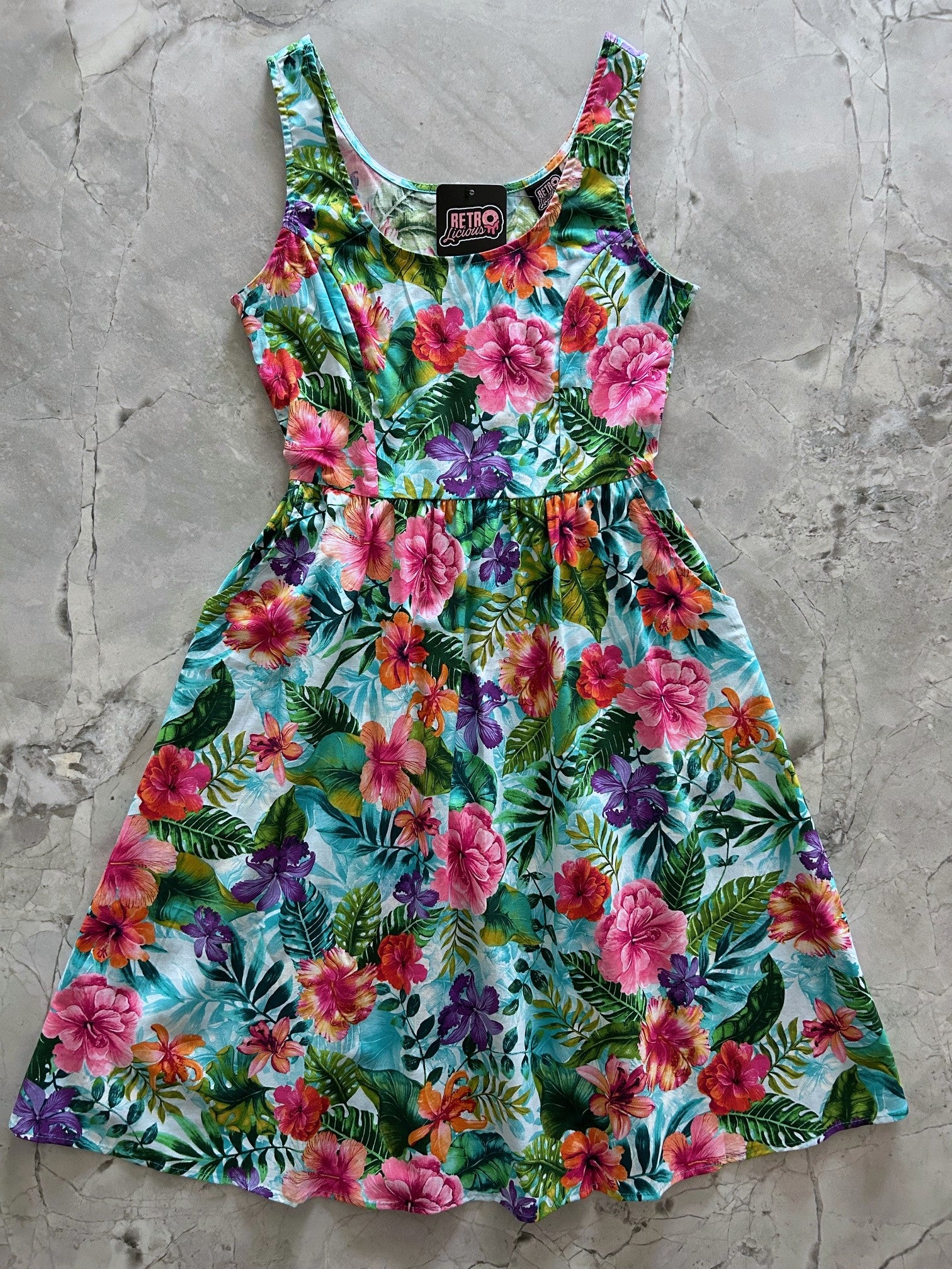 flat lay of tropical fit and flare dress