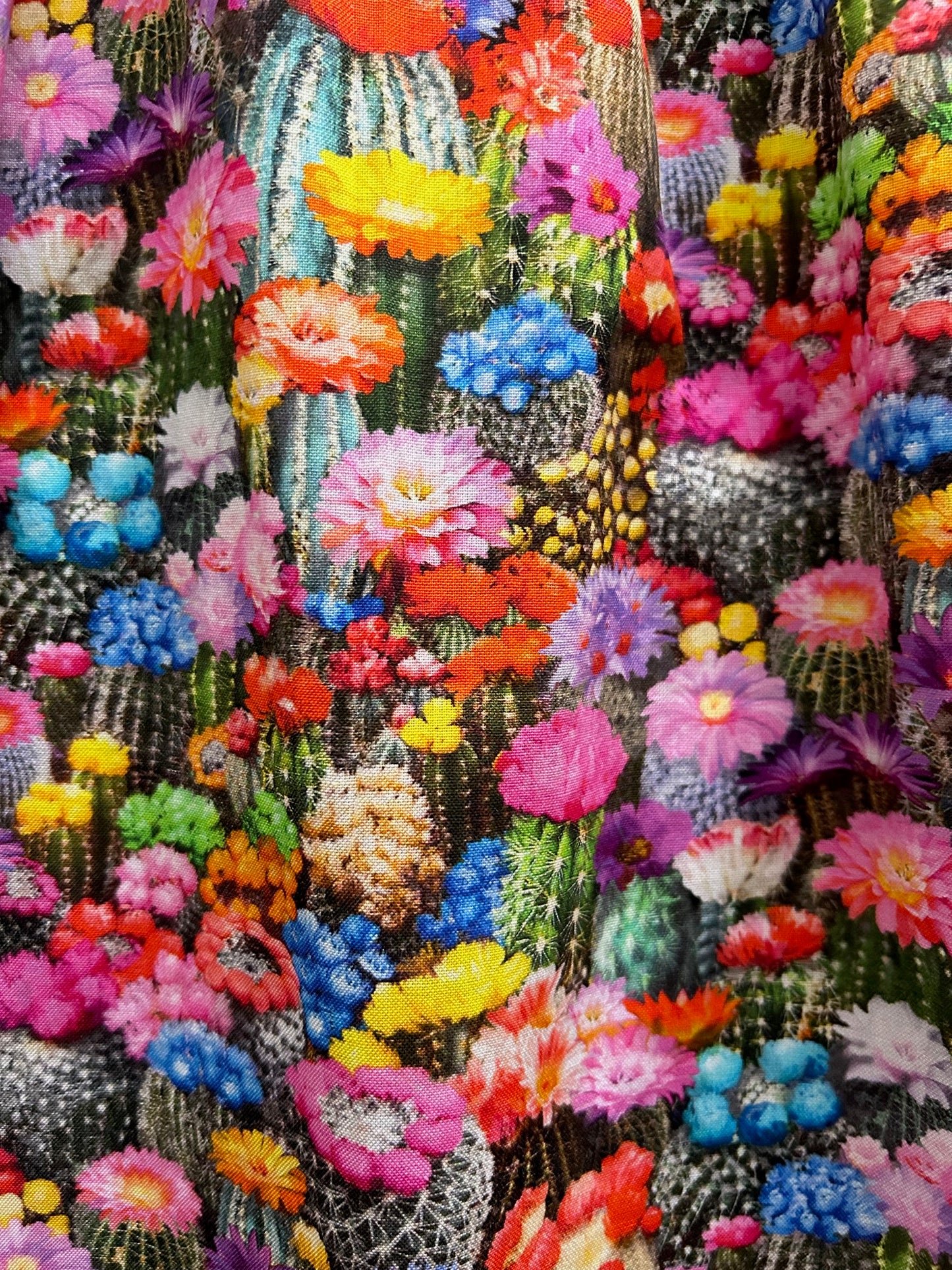 close up of the fabric showing the colorful cacti wtih flowers