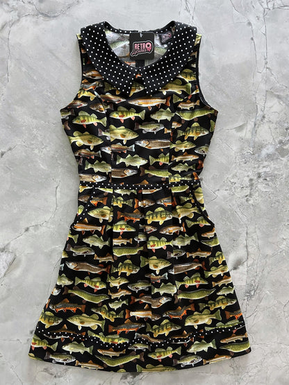 flat lay of fish collared dress showing the black and white polka dot trim and collar