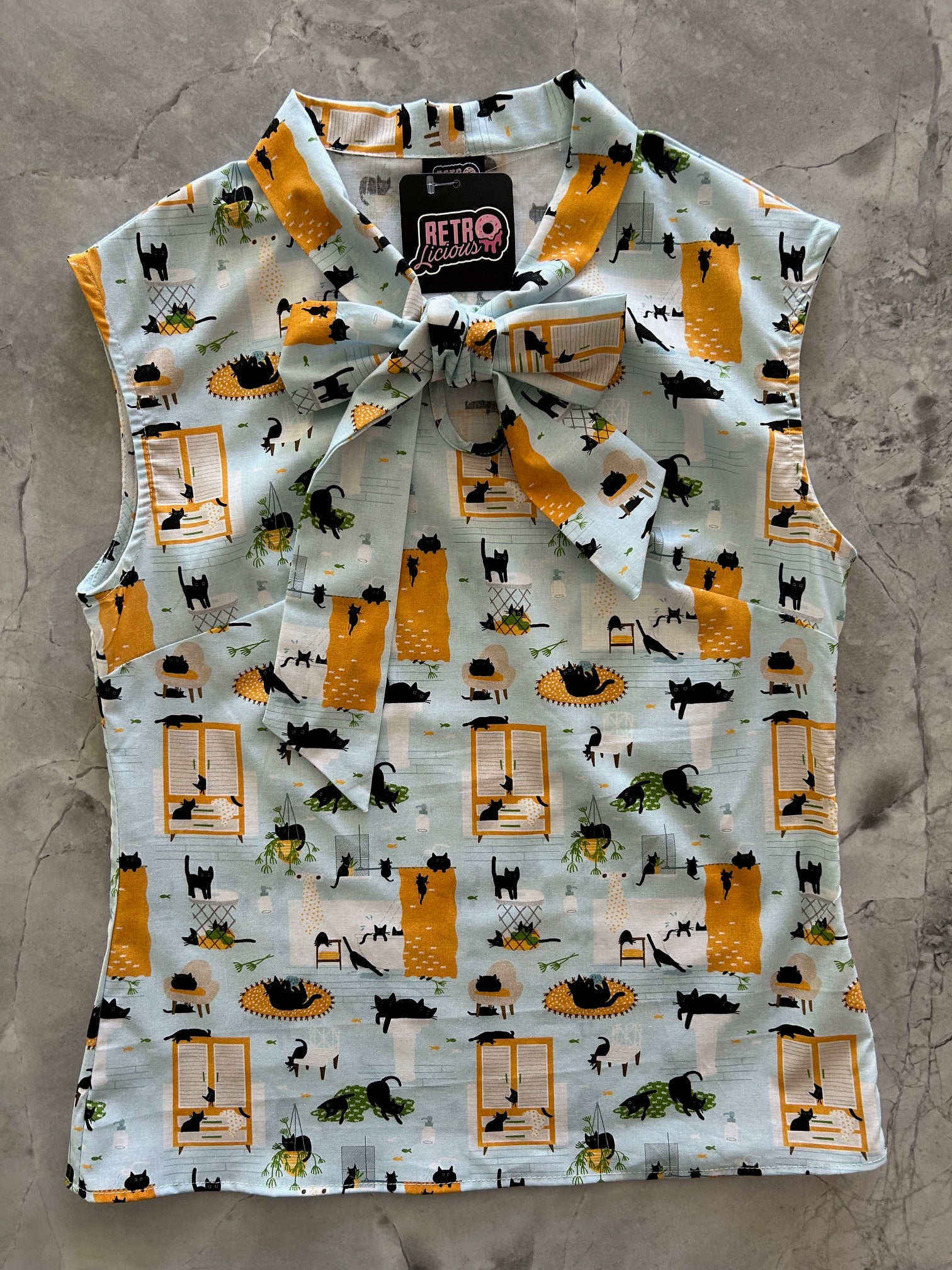 flatlay of cats bow top