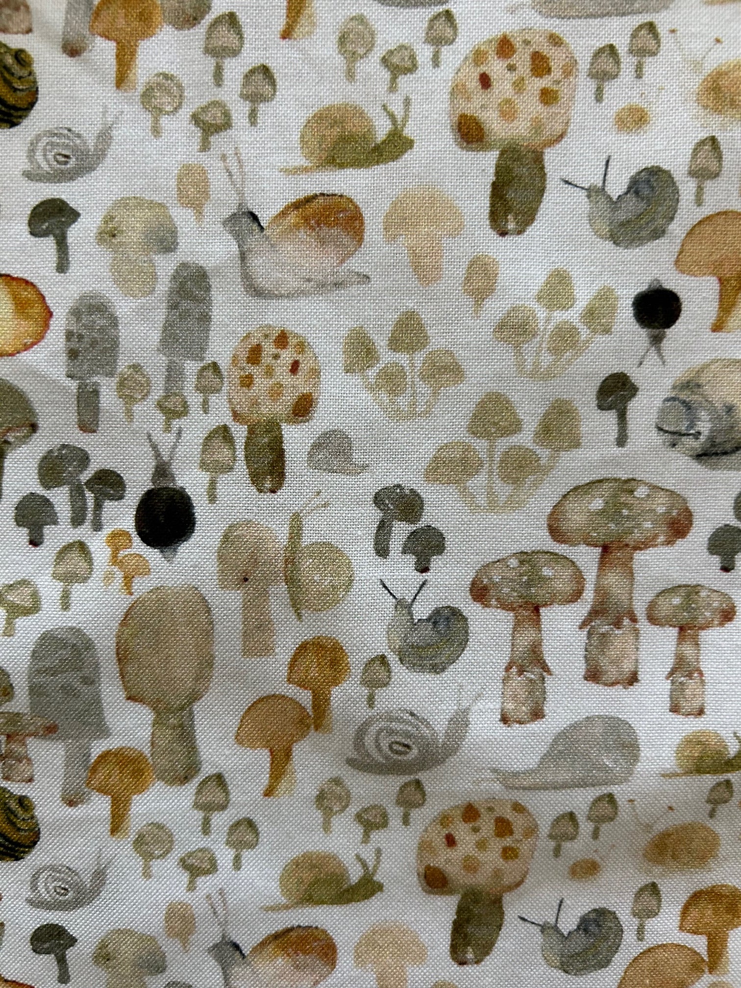 close up of fabric showing mushrooms and snails