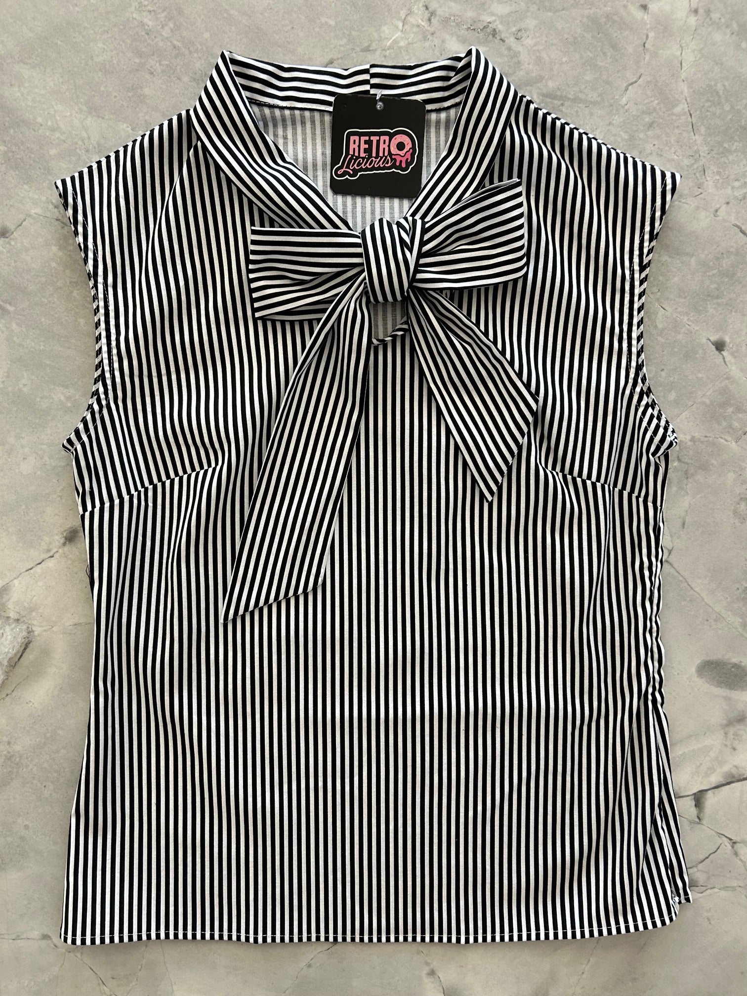 flat lay of black and white striped bow top