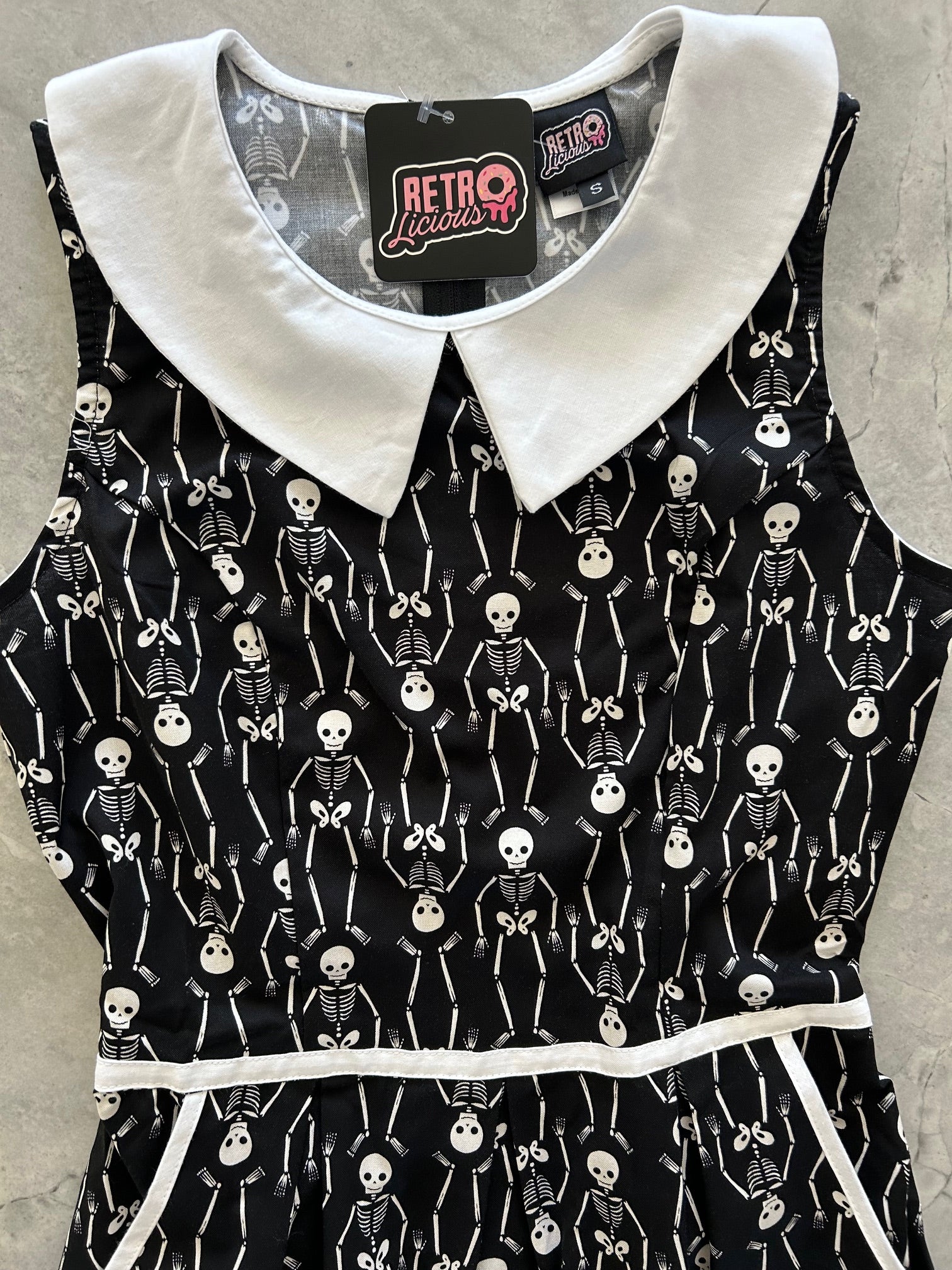 close up of the bodice of skeleton collared dress showing collar and piping detail