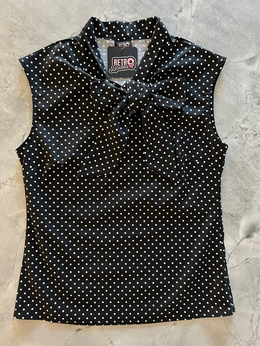 flatlay of black polka dot bow top