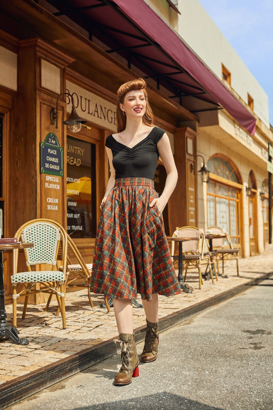 model wearing red plaid doris skirt hands in her pockets