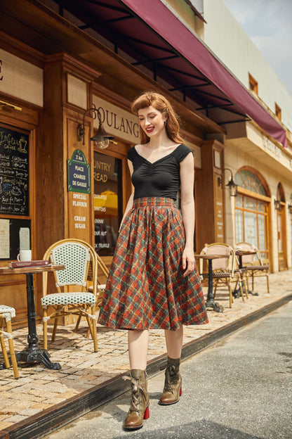 model wearing red plaid doris skirt walking near shops