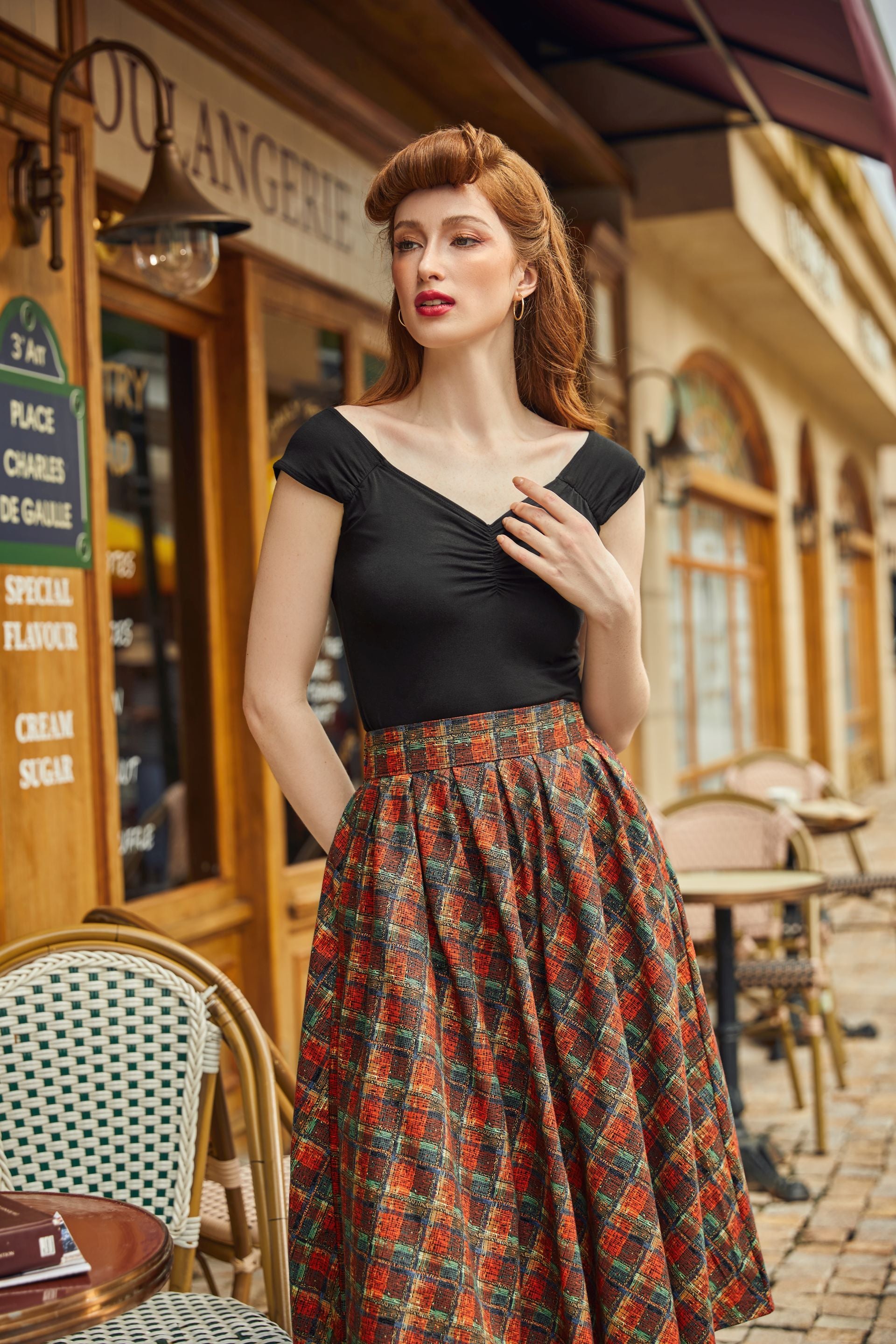 model wearing red plaid doris skirt with black isabel top