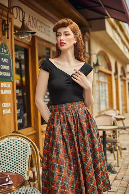 model wearing red plaid doris skirt with black isabel top