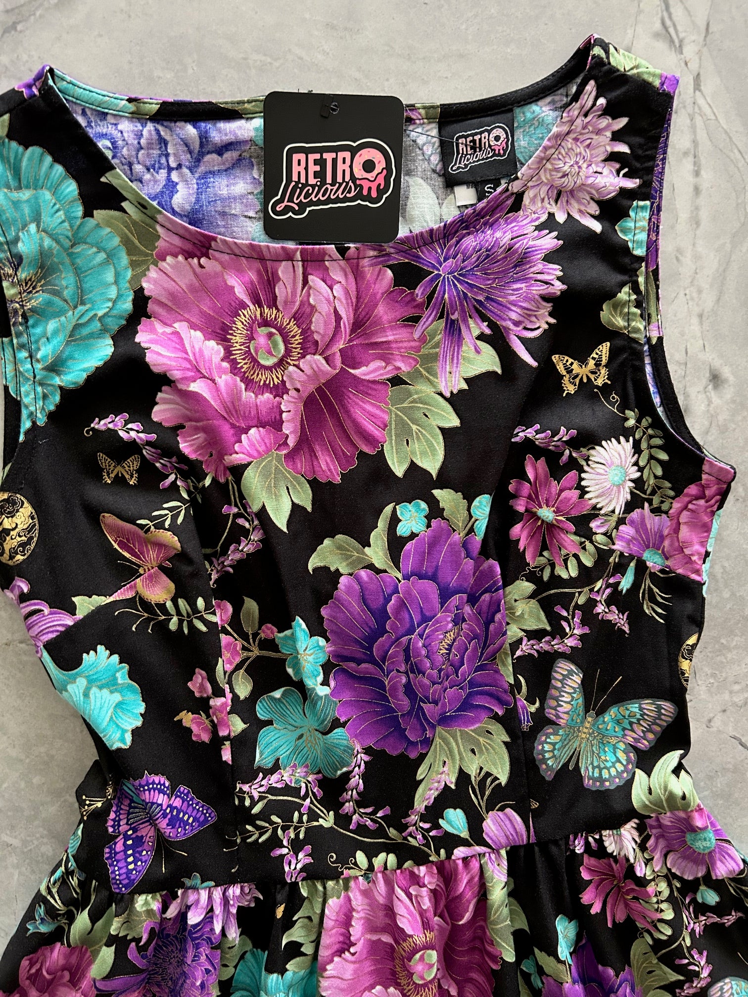 close up of bodice flatlay of butterfly floral vintage dress