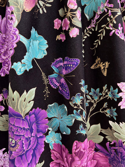 close up of print showing buttefly and flowers on black background