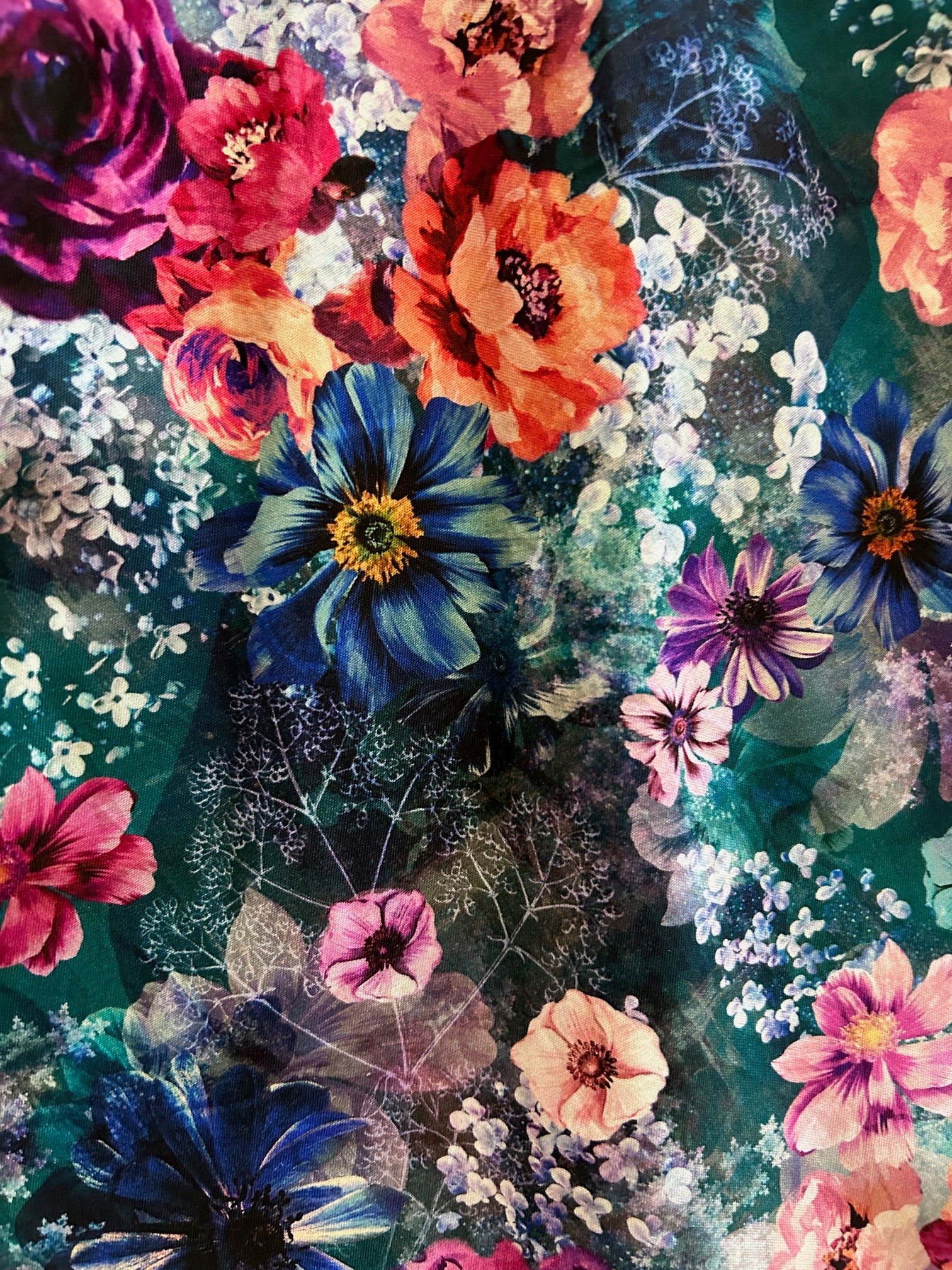close up of the flatlay of moody floral vintage dress showing darker floral print