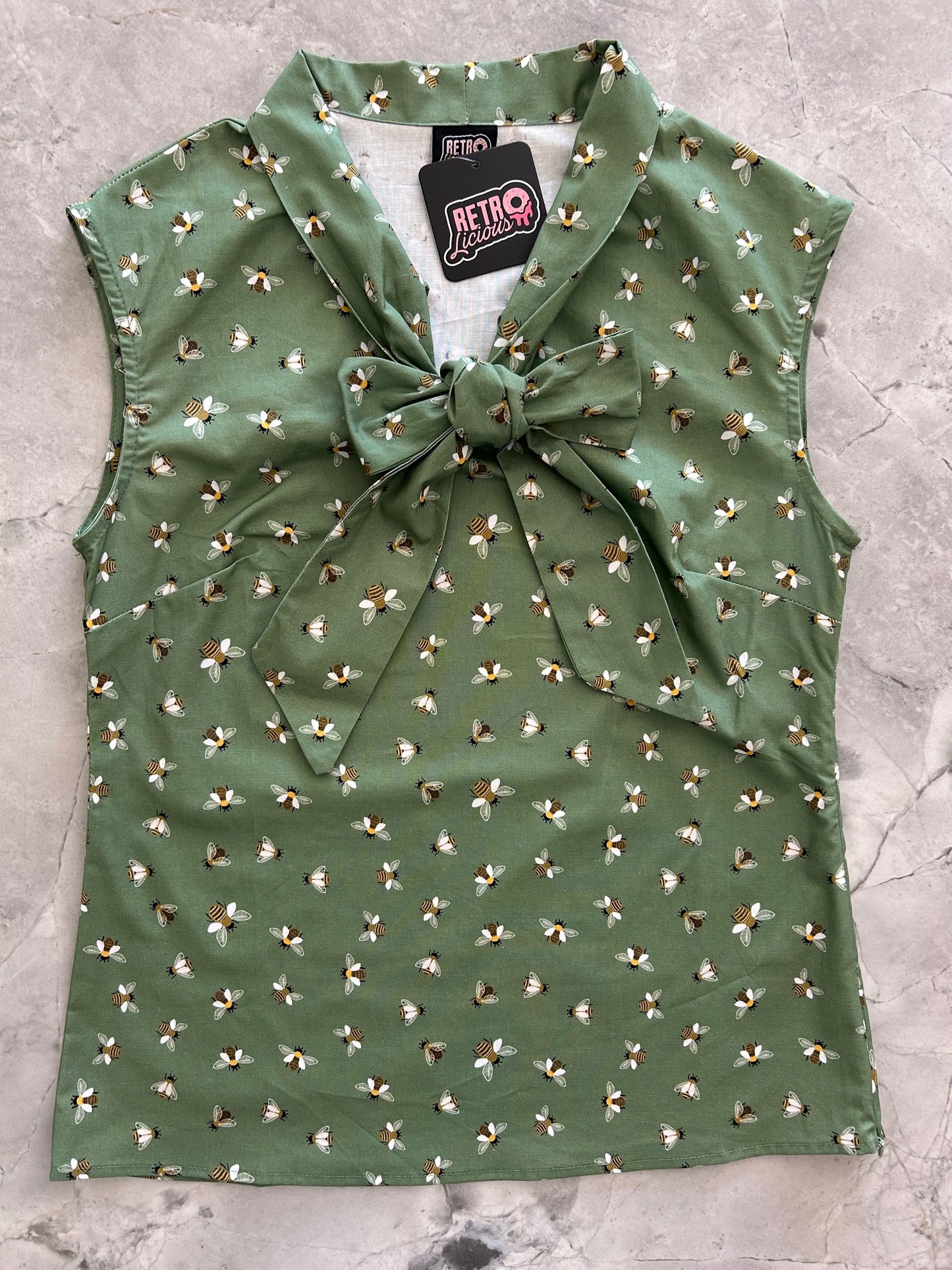 flatlay of bee bow top