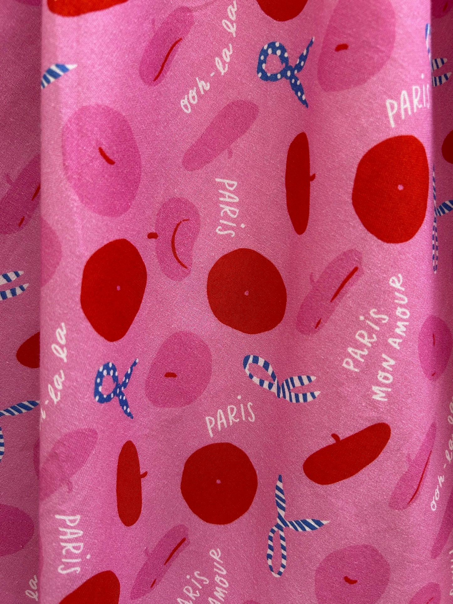 close up of the paris print showng the tossed berets and scarves