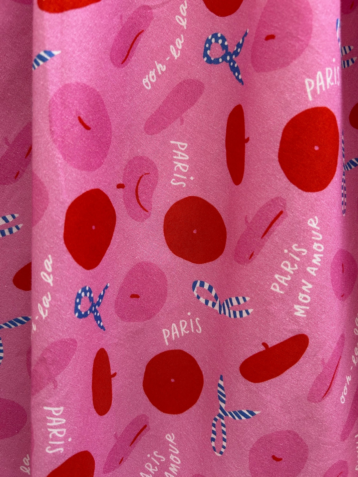 close up of the paris print showng the tossed berets and scarves