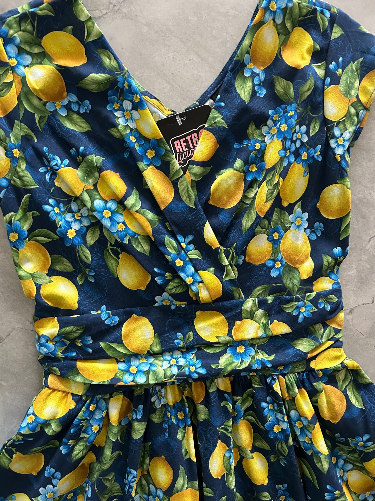 close up of bodice flatlay of lemon floral greta dress