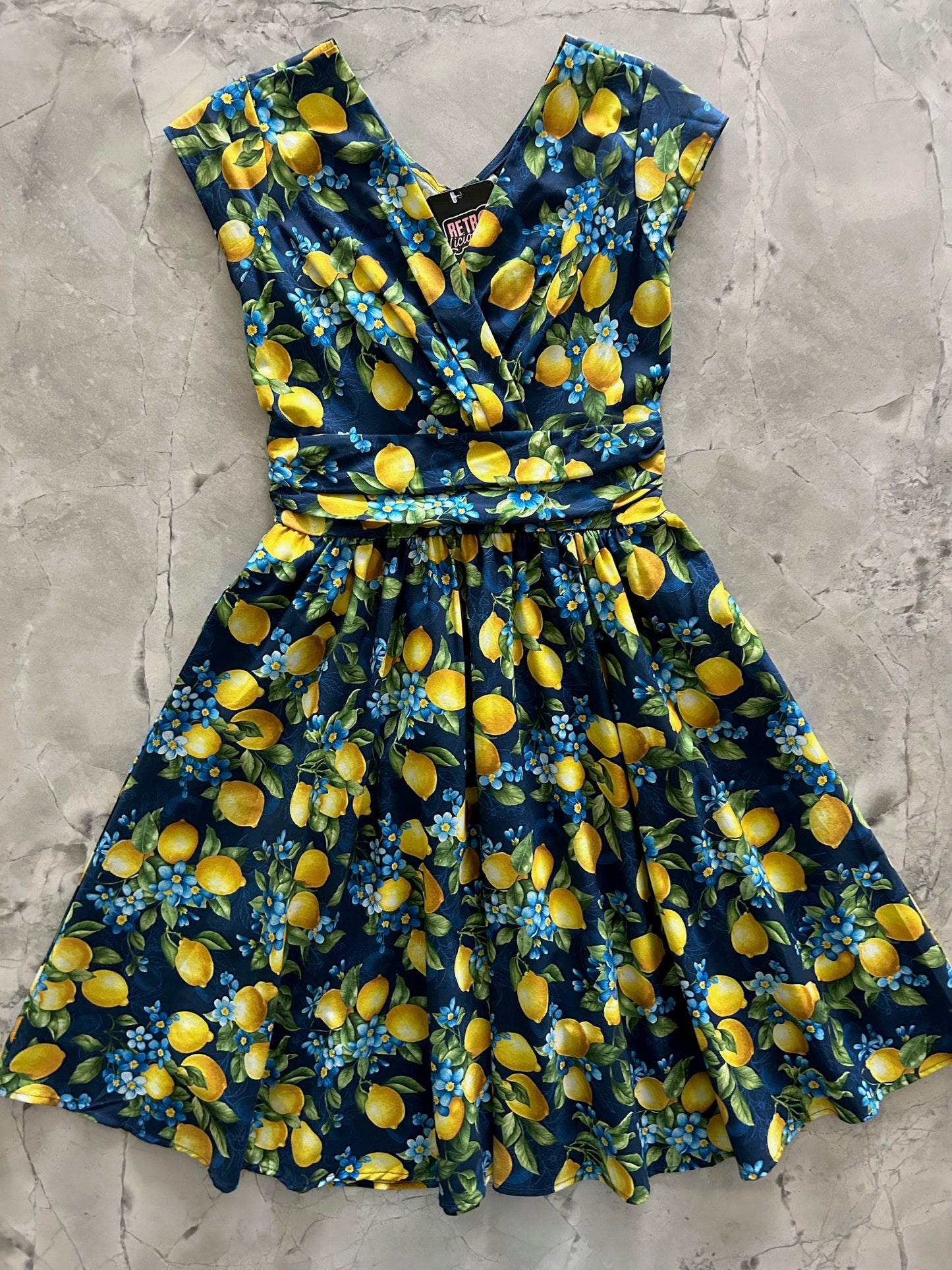 flatlay of lemon floral greta dress