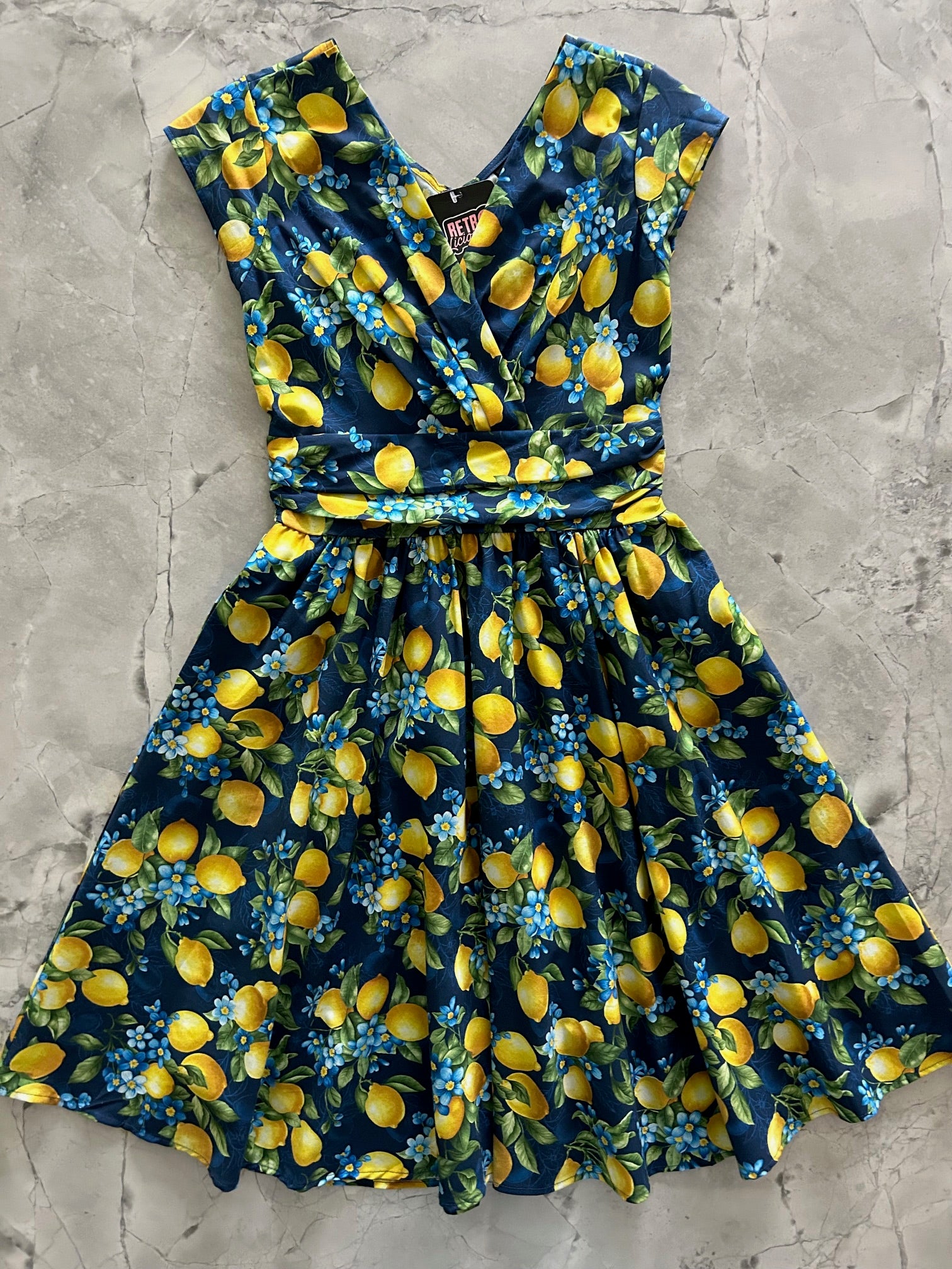 flatlay of lemon floral greta dress