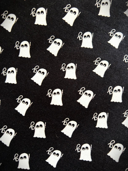 close up of mini ghosts print on black background