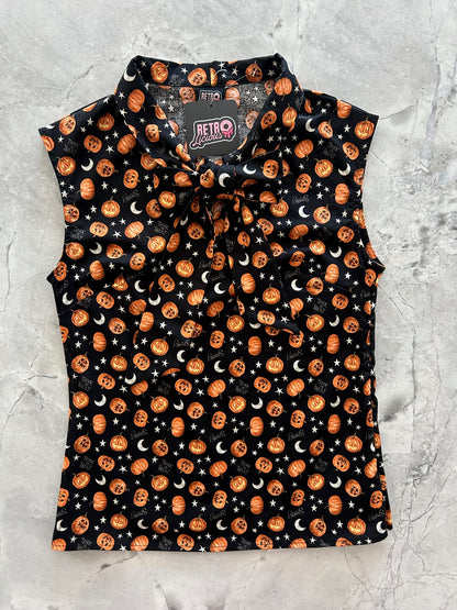 flatlay of jack-o-lantern bow top