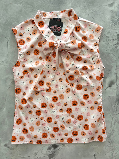 flatlay of pink jack-o-lantern bow top