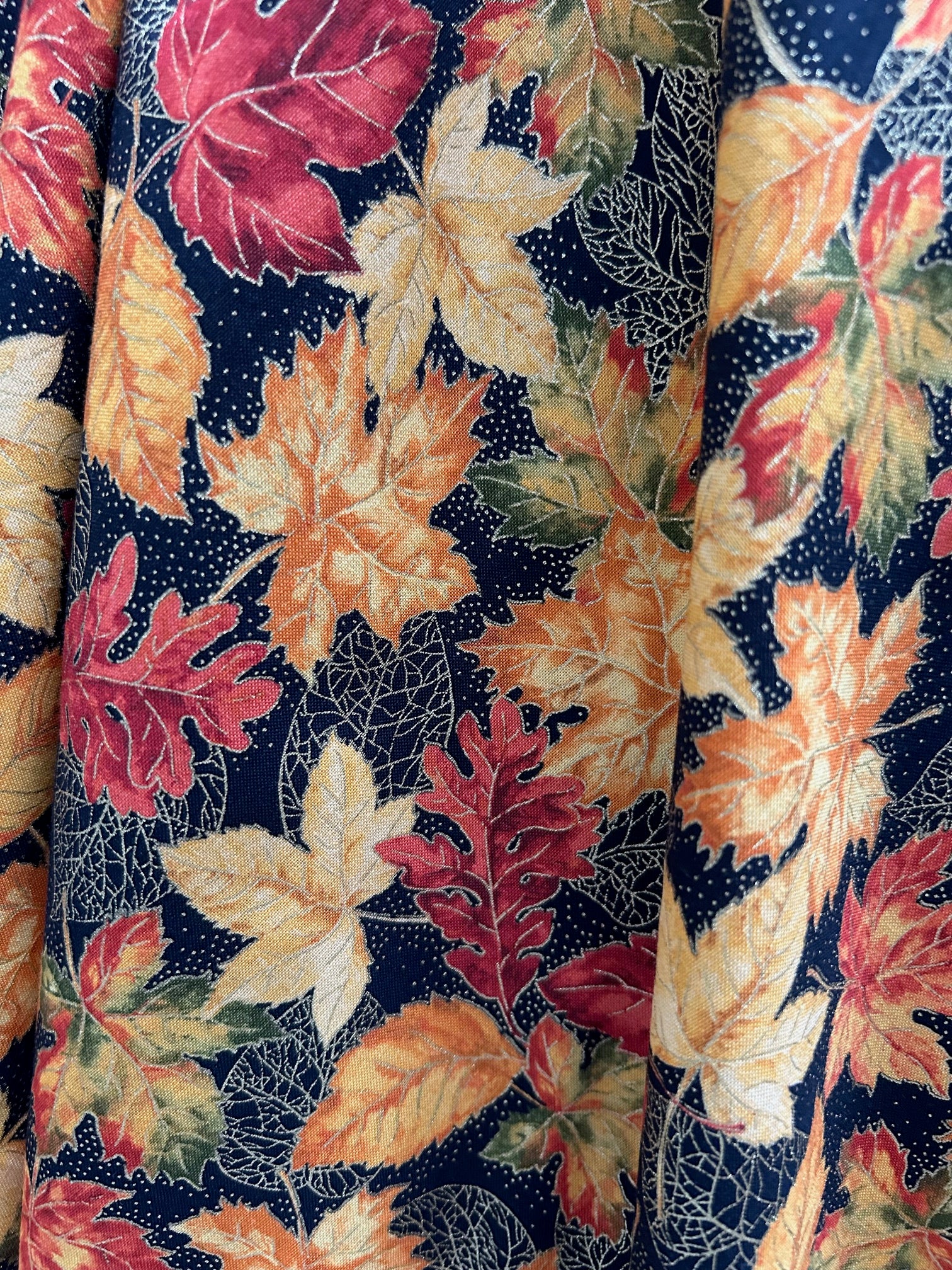 Fabric with autumn leaf pattern on a black background