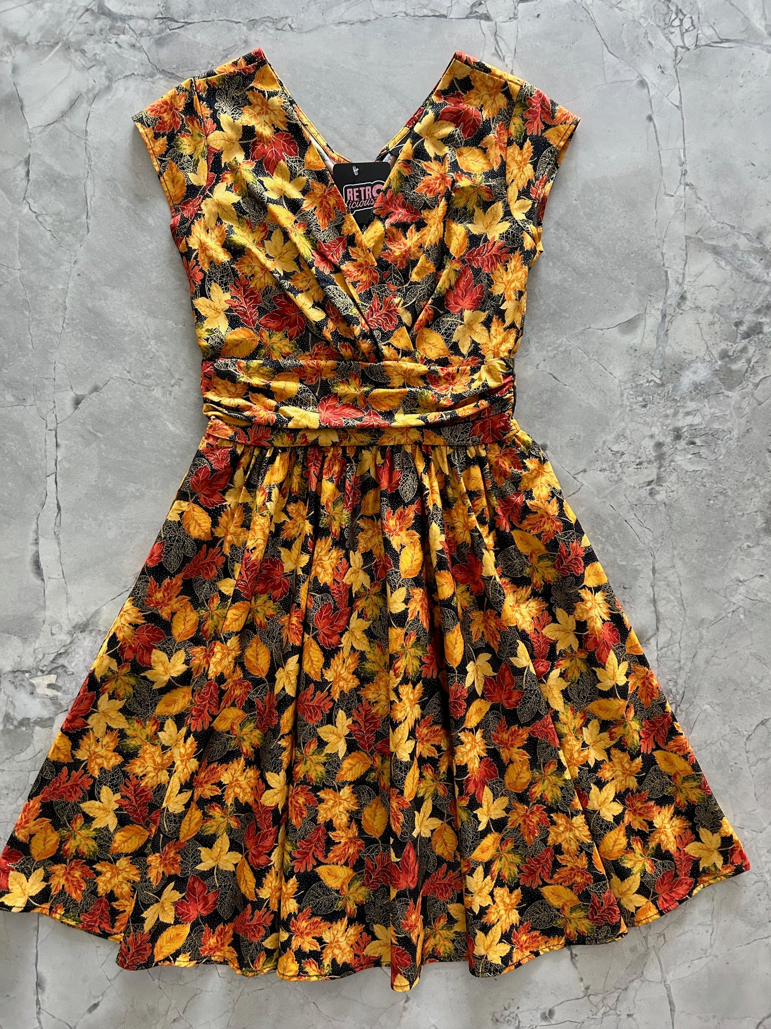 flatlay of fall leaves greta dress