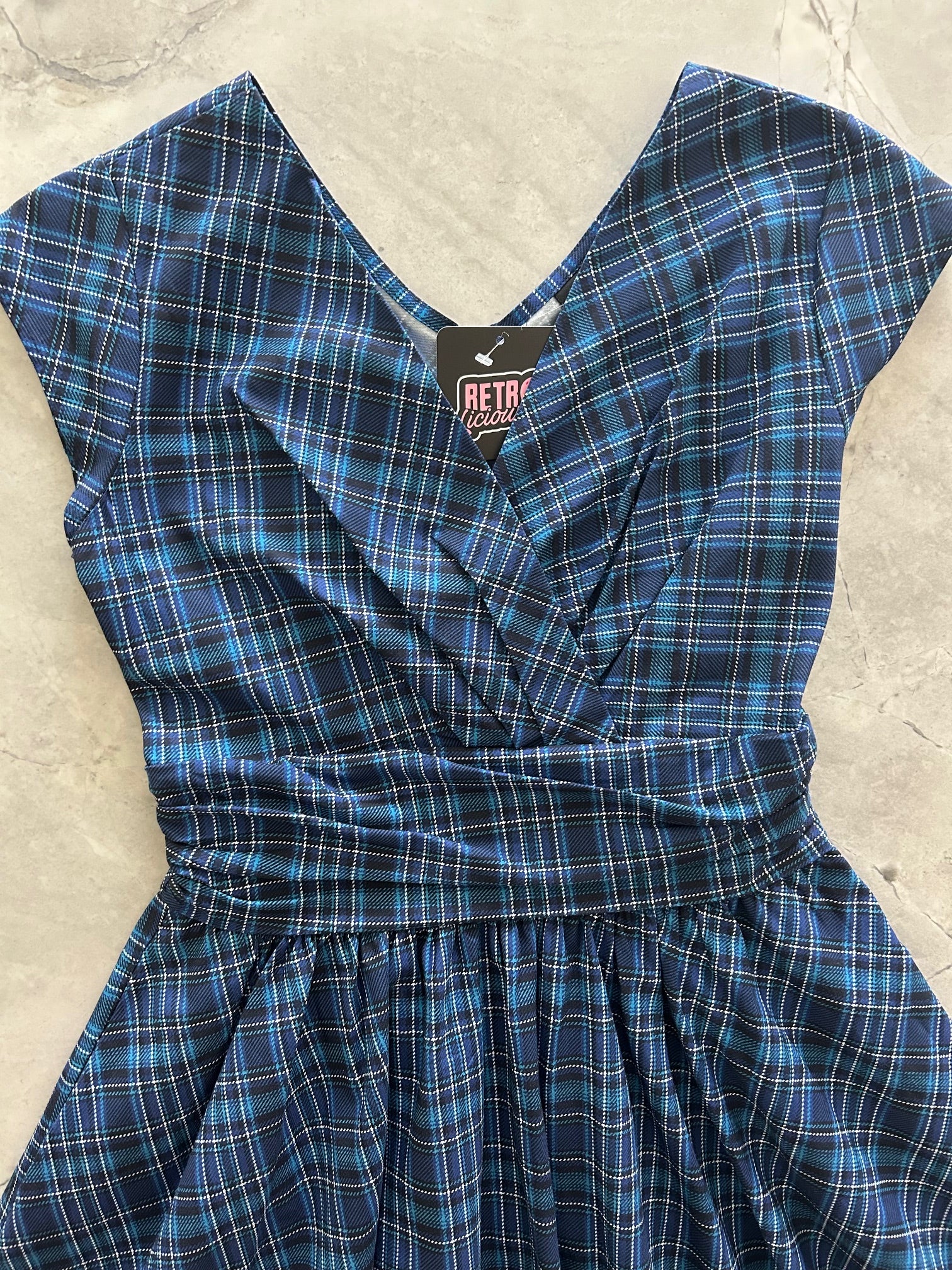 flatlay of the bodice of our blue plaid greta dress