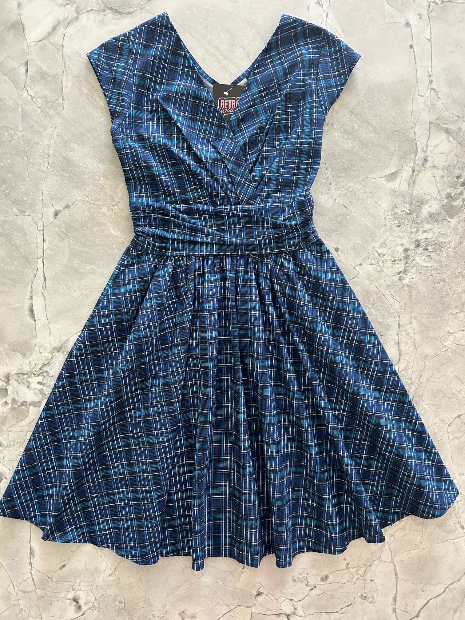 flatlay of our blue plaid greta dress