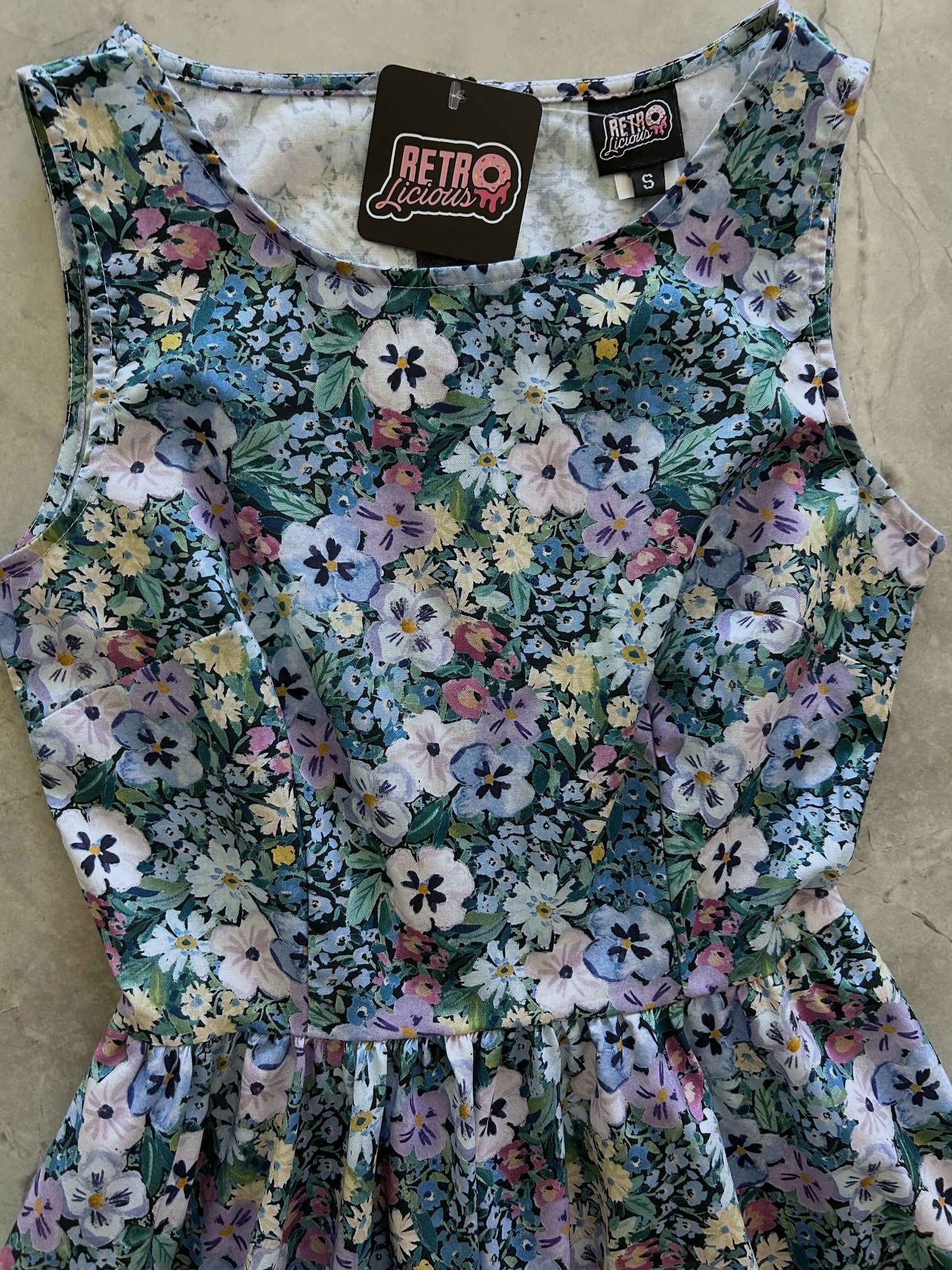 flatlay of front bodice of painted floral vintage dress