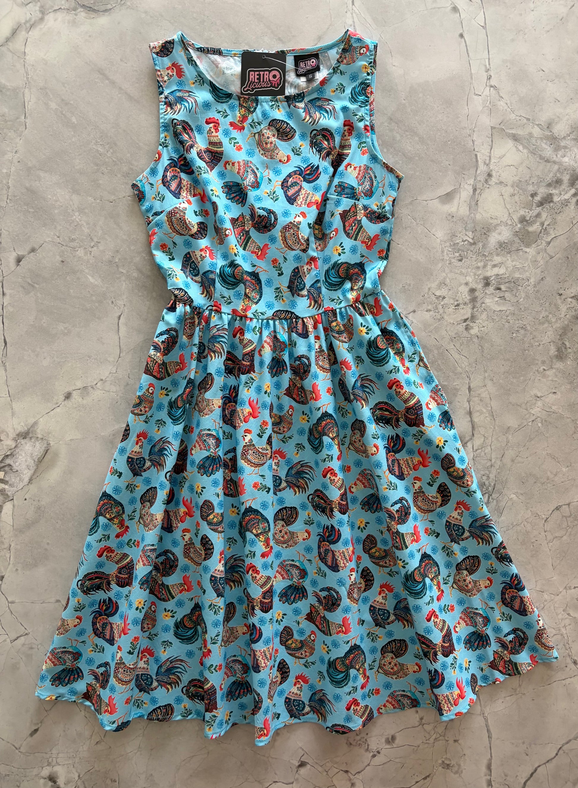 Dress with rooster pattern on a textured surface