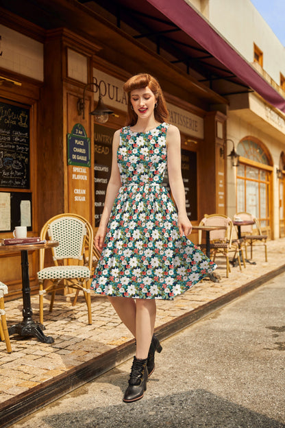 model wearing winter floral vintage dress on a sidewalk near a cafe and shops