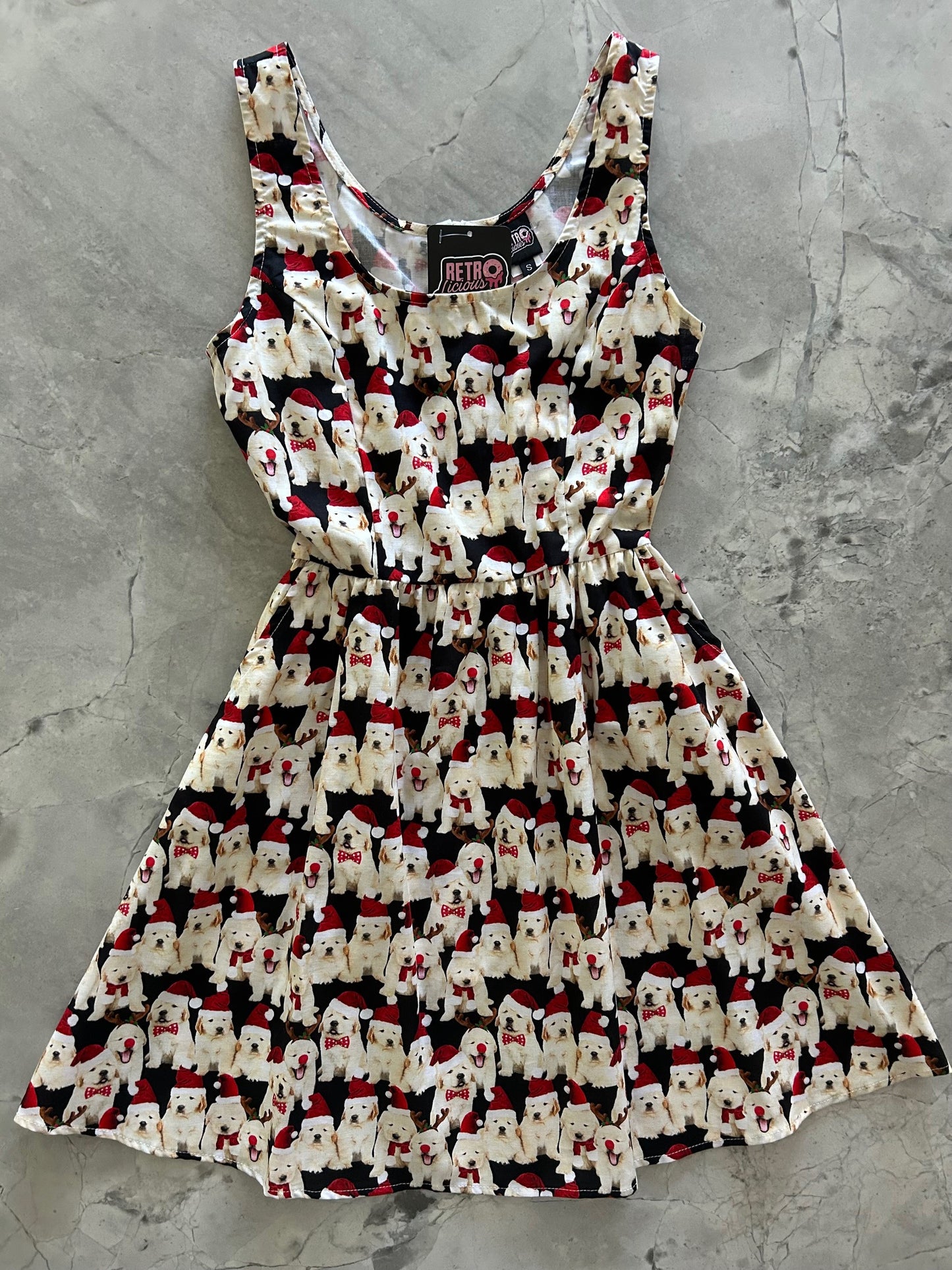 flatlay of dogs in santa hats on black background