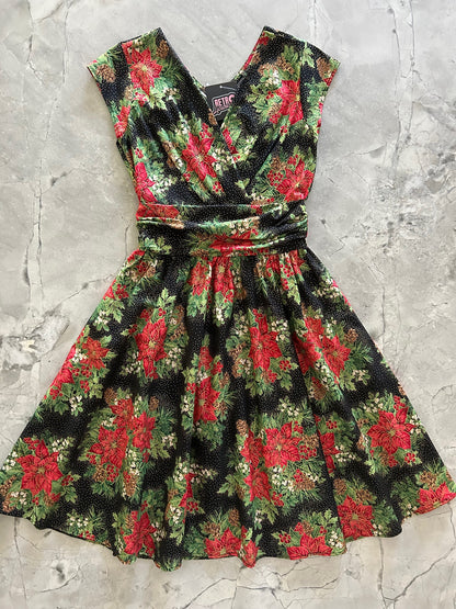flatlay of red poinsettias on black background greta dress